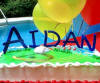 royal blue colored acrylic boy's birthday cake in kindergarten font