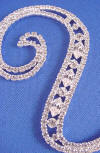 swarovski (tm) crystals cover the front side of this vintage font sterling silver plated wedding cake topper