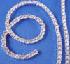 close-up of the rhinestones on this renaissance letter w wedding cake topper