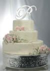 crystal-accented metal single initial wedding cake topper