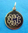 A sterling silver monogramed round charm