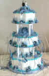 blue wedding cake with cake charms on blue ribbons
