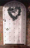 heart-shaped wedding wreath on entrance door