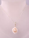 our white mother of pearl calla lily necklace in 14k yellow gold
