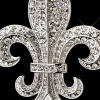 close-up of new orleans fleur de lis crystal wedding cake topper