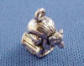 sterling silver petite bear on a log charm