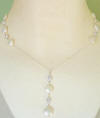 This coin pearl necklace has 2 coin pearl and cz stations on the sides and a dangle coin pearl cz drop.