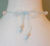 organza necklace tied in a bow on the back of the neck